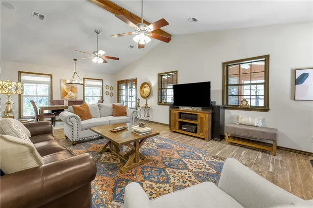 a living room with furniture and a floor to ceiling window