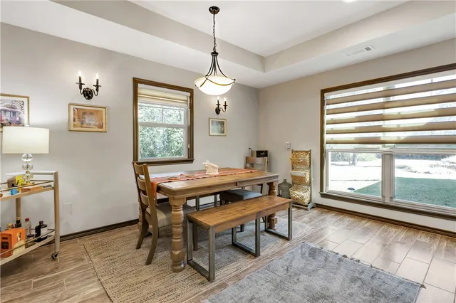 a view of kitchen with refrigerator and wooden floor