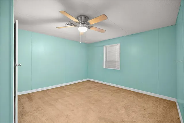 a bedroom with a bed and a ceiling fan