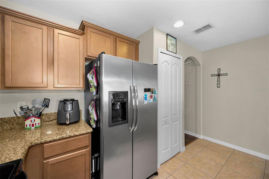 9736 Trumpet Vine Loop Trinity, FL 34655 - Photo 20 of 35 a kitchen with stainless steel appliances granite countertop a refrigerator and a sink