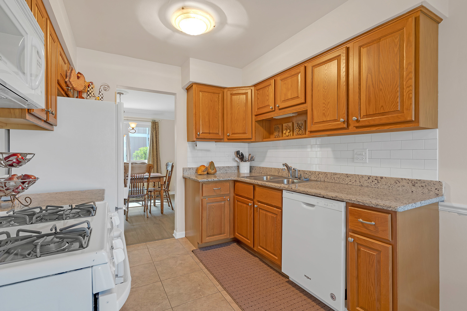 1256 Reading Court Wheaton, IL 60189 - Photo 7 of 34 a kitchen with stainless steel appliances granite countertop a sink stove and cabinets