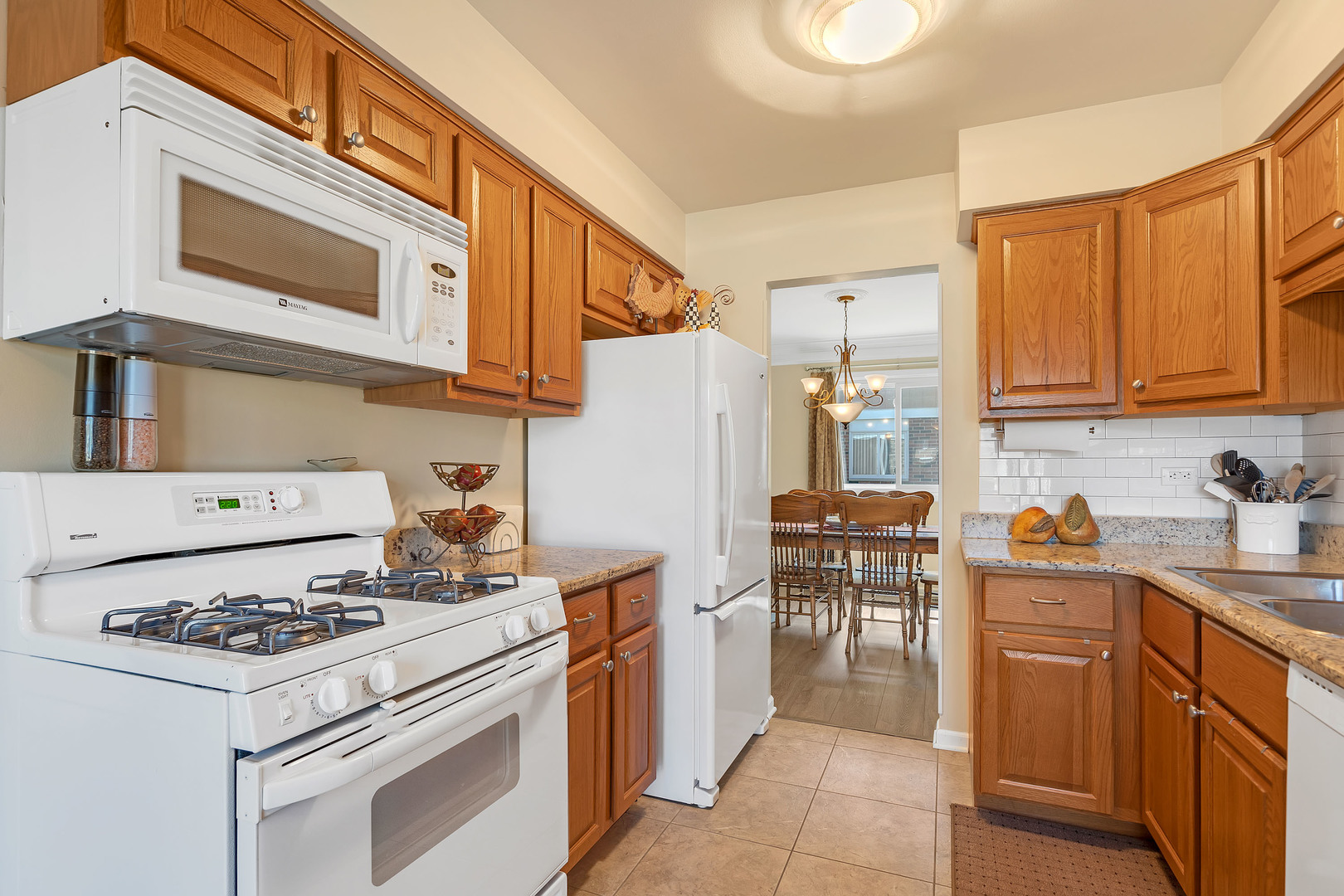 1256 Reading Court Wheaton, IL 60189 - Photo 8 of 34 a kitchen with stainless steel appliances a stove a sink and a refrigerator