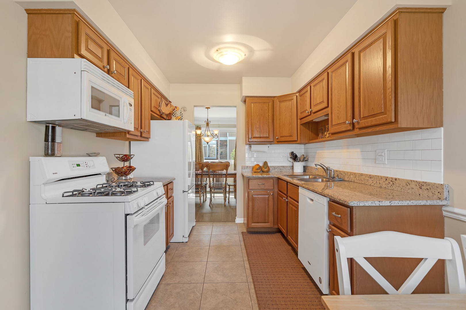 1256 Reading Court Wheaton, IL 60189 - Photo 9 of 34 a kitchen with stainless steel appliances granite countertop a stove and a refrigerator