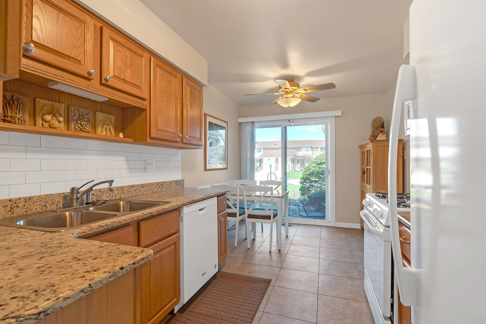 1256 Reading Court Wheaton, IL 60189 - Photo 10 of 34 a kitchen with a sink a counter top space appliances and cabinets