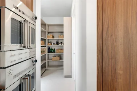 a kitchen with stainless steel appliances cabinets and window