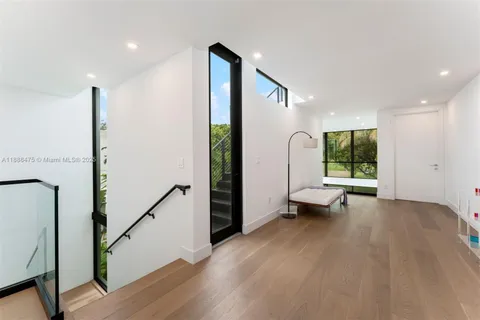 a bedroom with a large bed and a large window