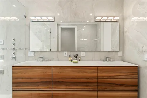 a view of an empty room with wooden floor and staircase