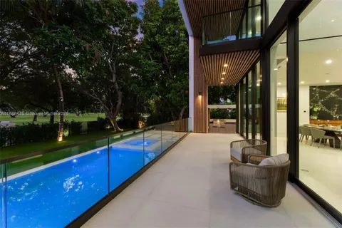 an aerial view of residential houses with outdoor space and trees
