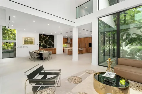 a kitchen with a sink dining table and chairs