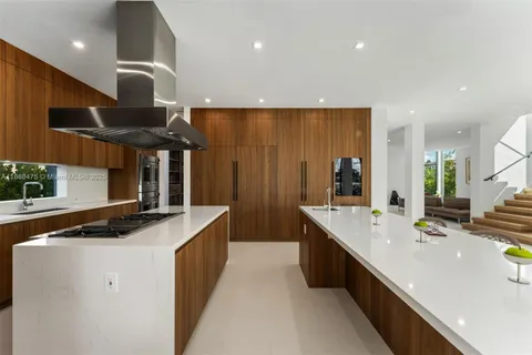 a kitchen with stainless steel appliances granite countertop a sink and a refrigerator