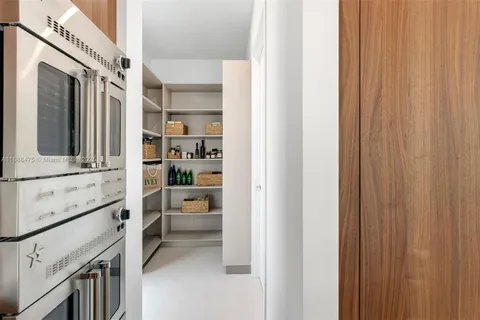a bathroom with a double vanity sink a toilet and a mirror