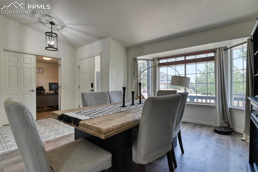 8820 Oakmont Road Peyton, CO 80831 - Photo 13 of 50 a view of a dining room with furniture window and wooden floor