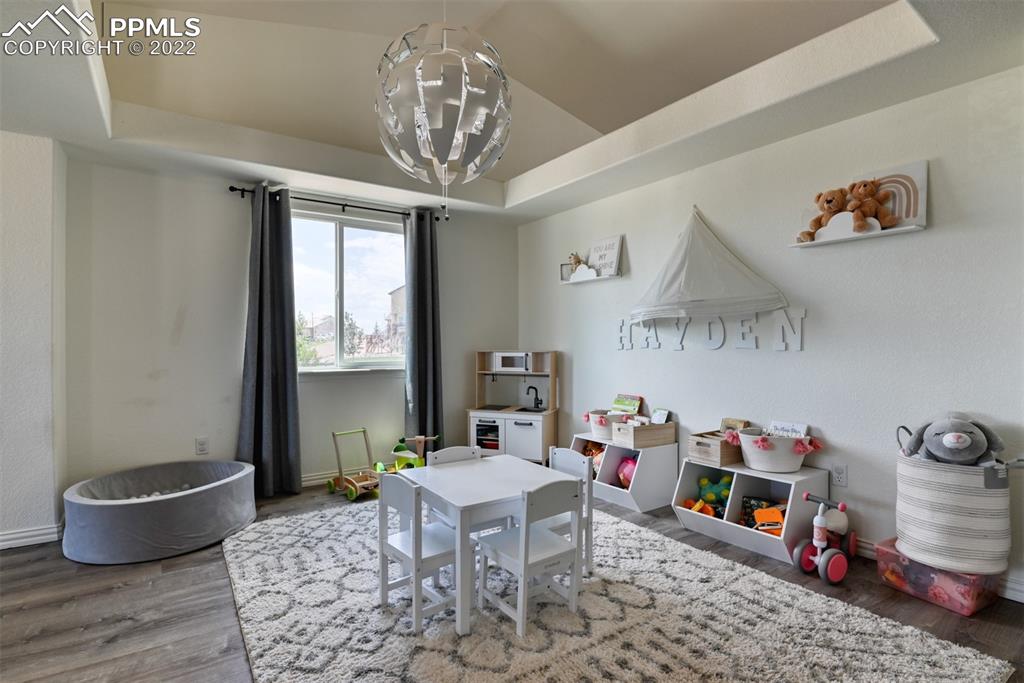 8820 Oakmont Road Peyton, CO 80831 - Photo 16 of 50 a living room with furniture and a chandelier