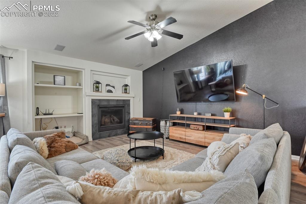 8820 Oakmont Road Peyton, CO 80831 - Photo 22 of 50 a living room with furniture and a fireplace