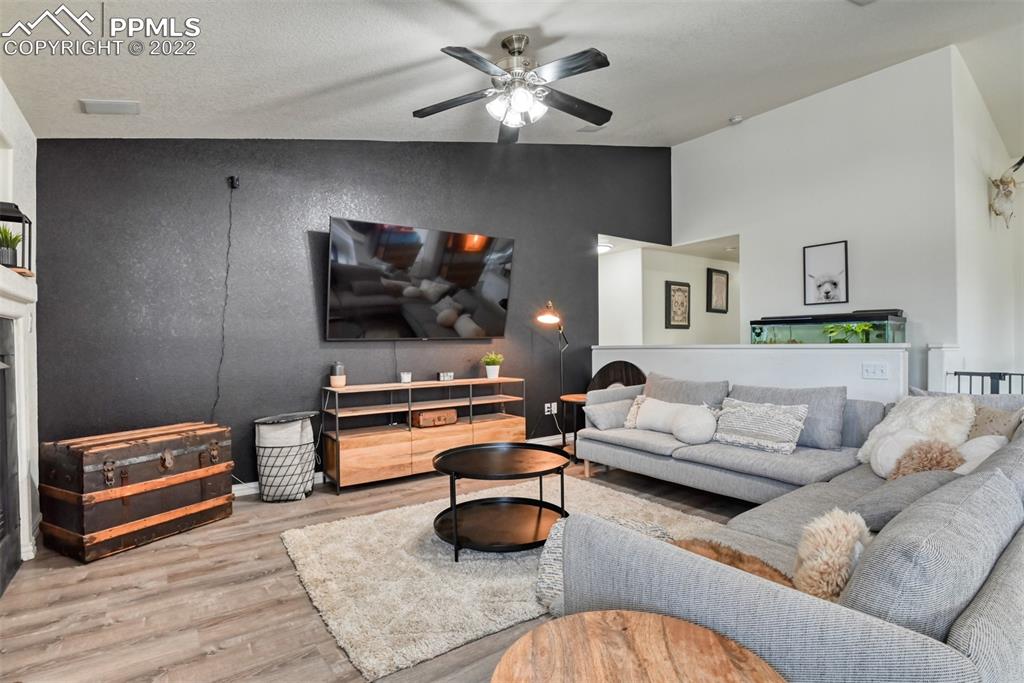 8820 Oakmont Road Peyton, CO 80831 - Photo 23 of 50 a living room with furniture and a flat screen tv