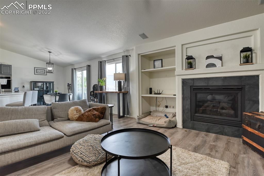 8820 Oakmont Road Peyton, CO 80831 - Photo 25 of 50 a living room with furniture and a fireplace
