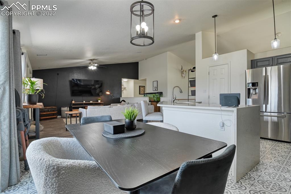 8820 Oakmont Road Peyton, CO 80831 - Photo 29 of 50 a kitchen with stainless steel appliances granite countertop a sink a stove and a refrigerator
