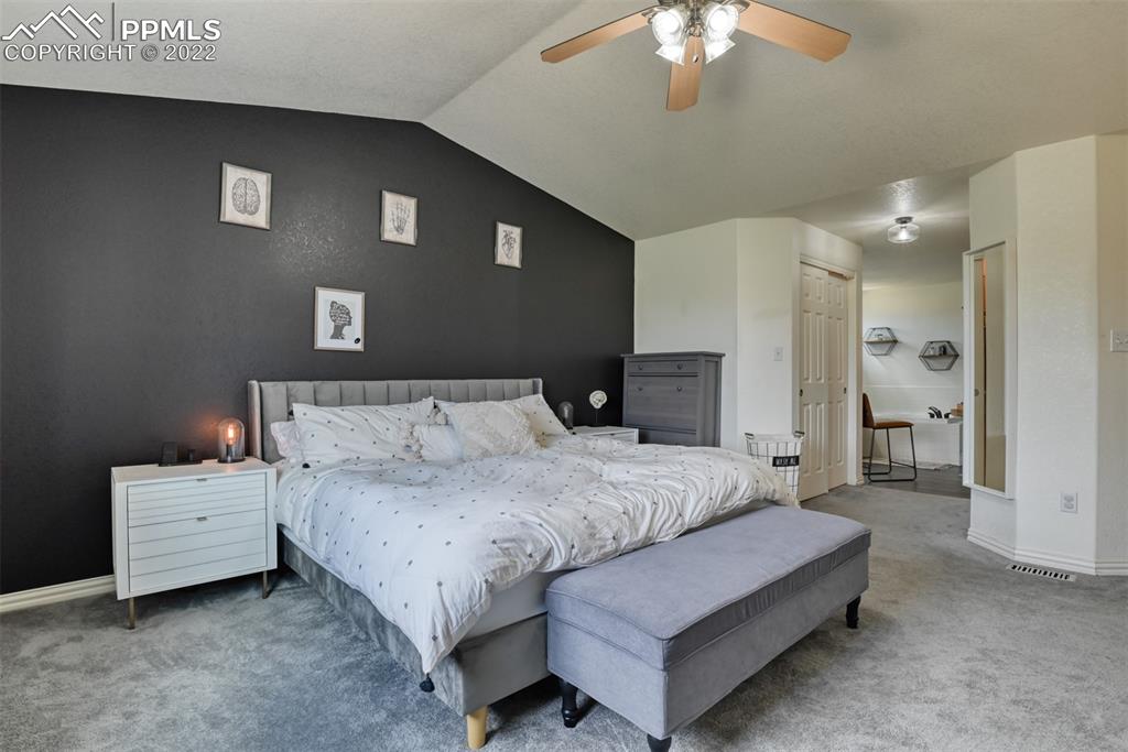 8820 Oakmont Road Peyton, CO 80831 - Photo 37 of 50 a bedroom with bed and a chandelier