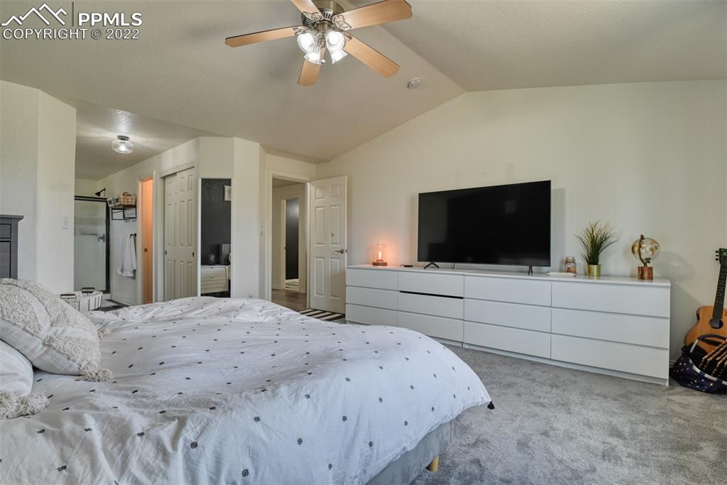 8820 Oakmont Road Peyton, CO 80831 - Photo 38 of 50 a bedroom with a bed and a flat screen tv