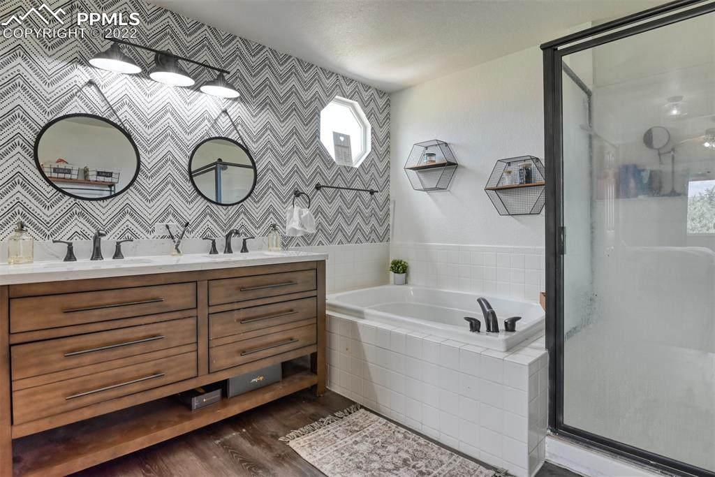 8820 Oakmont Road Peyton, CO 80831 - Photo 40 of 50 a bathroom with a sink and a mirror