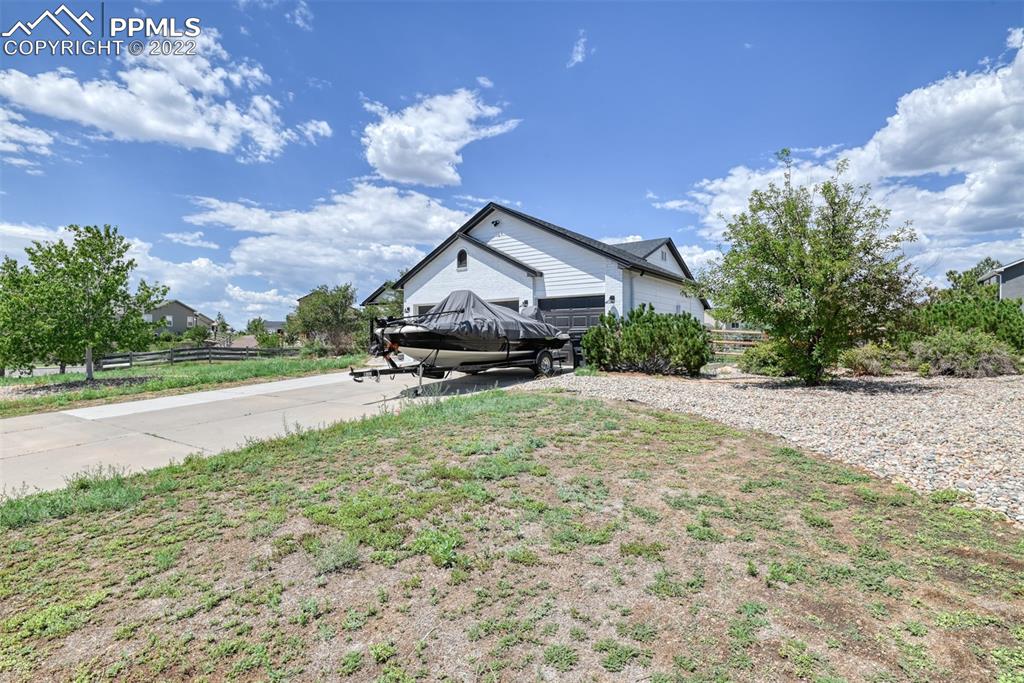 8820 Oakmont Road Peyton, CO 80831 - Photo 4 of 50 a house view with a garden space
