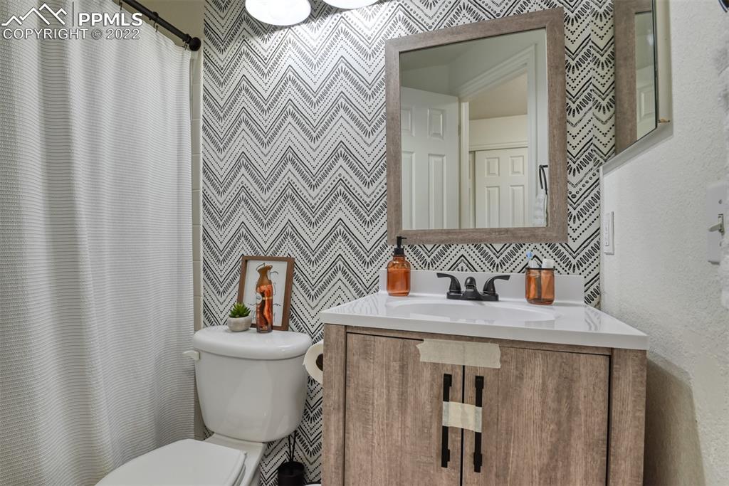 8820 Oakmont Road Peyton, CO 80831 - Photo 44 of 50 a bathroom with a sink a toilet and a mirror