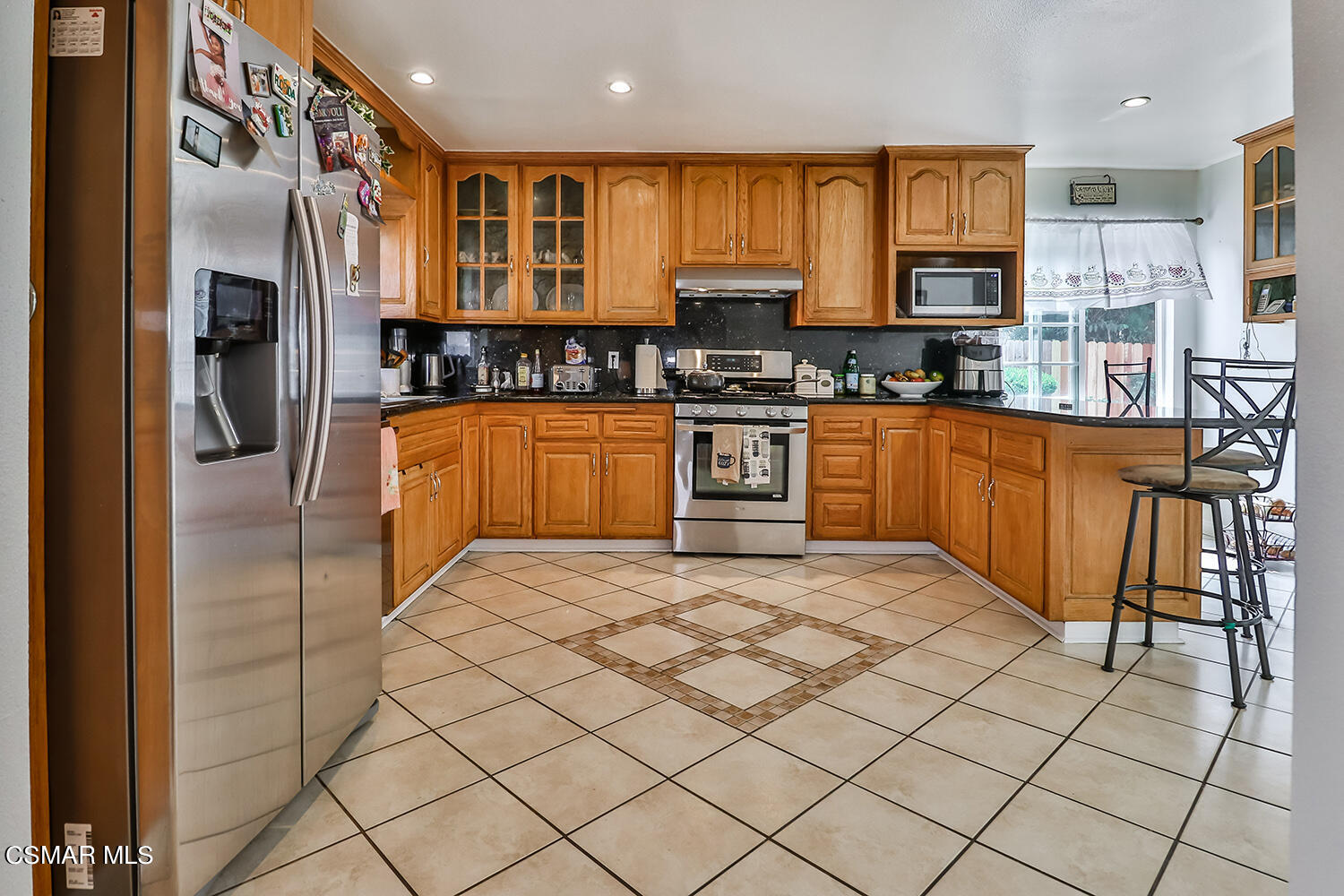 3964 Celia Court Simi Valley, CA 93063 - Photo 11 of 38 a large kitchen with stainless steel appliances granite countertop a stove and cabinets