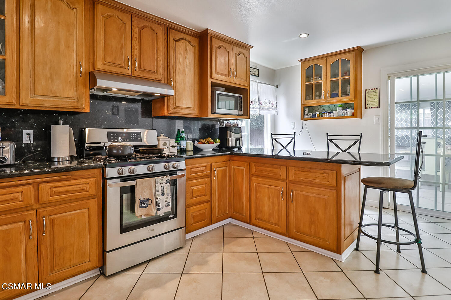 3964 Celia Court Simi Valley, CA 93063 - Photo 14 of 38 a kitchen with stainless steel appliances granite countertop a stove a sink and a microwave
