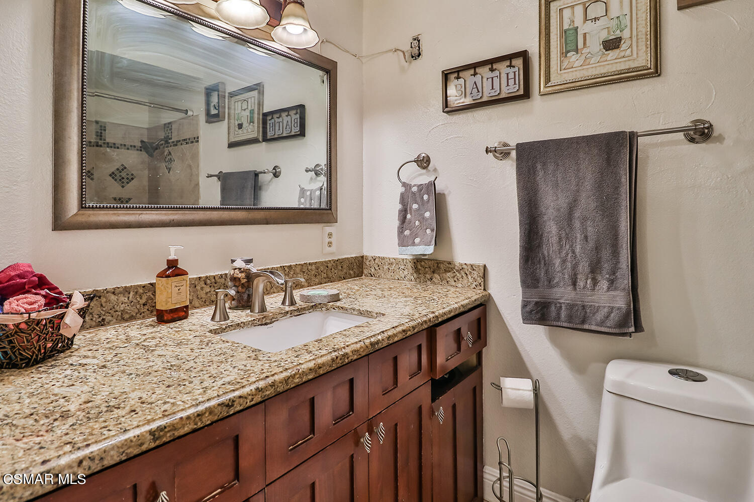 3964 Celia Court Simi Valley, CA 93063 - Photo 18 of 38 a bathroom with a granite countertop sink and a mirror