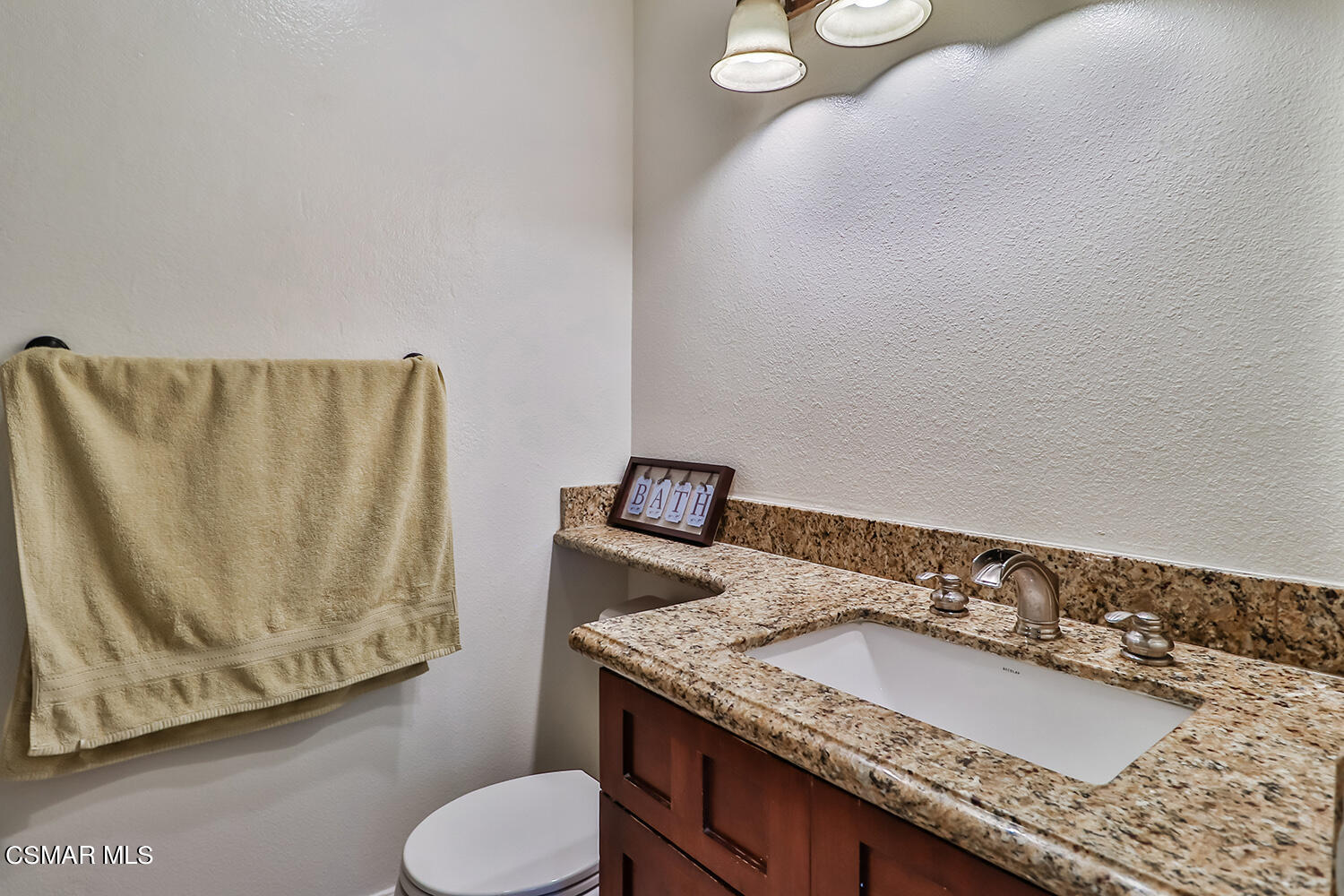3964 Celia Court Simi Valley, CA 93063 - Photo 23 of 38 a bathroom with a granite countertop sink and a mirror