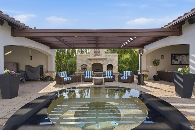 12308 Mariah Circle Draper, UT 84020 - Photo 143 of 293 Outdoor living area featuring a central spa with surrounding dark coping