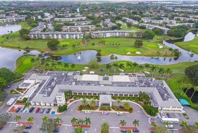 an aerial view of residential houses with outdoor space and swimming pool