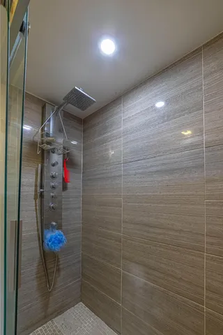 a bathroom with a shower and a sink