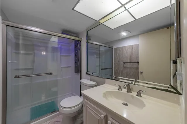a bathroom with a sink toilet and shower