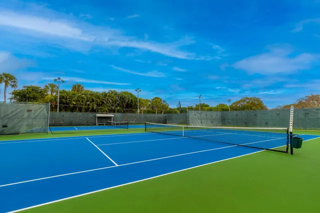 a view of tennis court with houses
