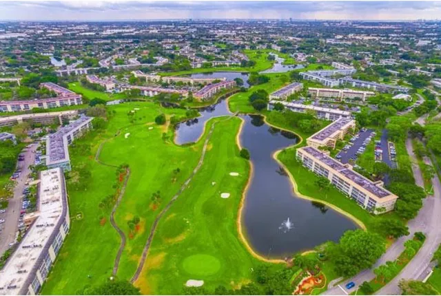 an aerial view of a golf course with parking space