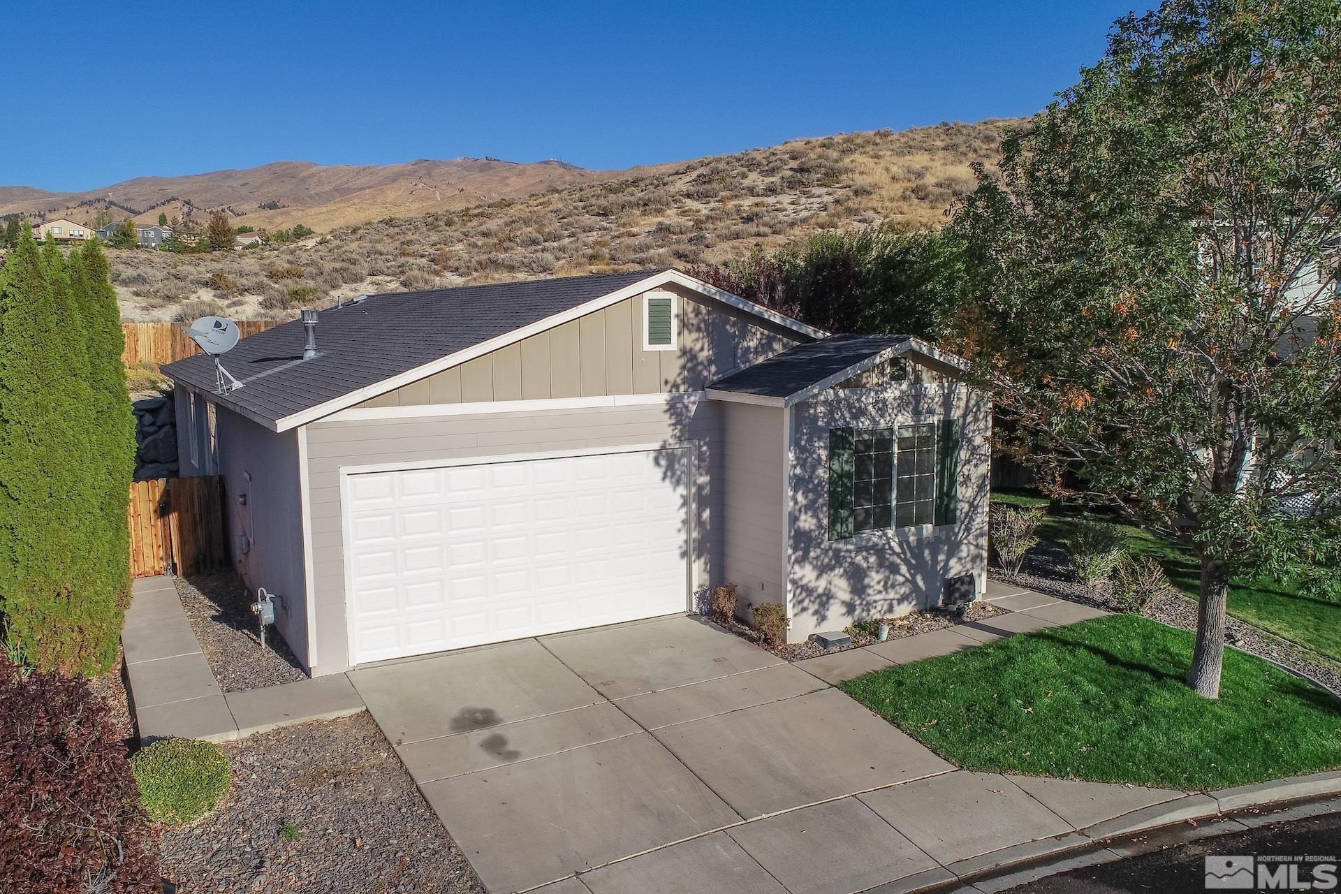 2424 Sapphire Ridge Way Reno, NV 89523 - Photo 1 of 40 a front view of a house with mountain view