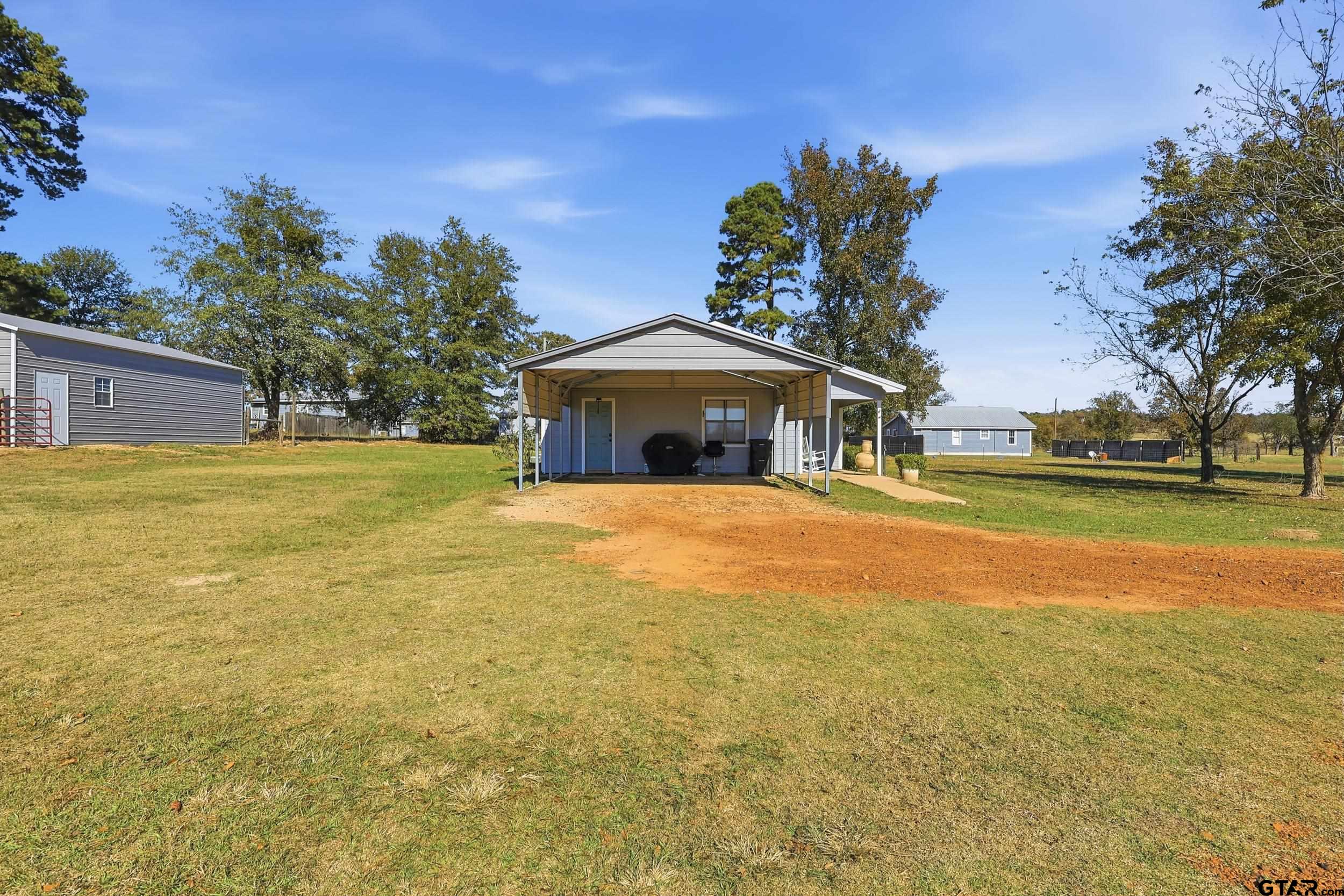 1775 County Road 1342 Pittsburg, TX 75686 - Photo 20 of 35 a front view of a house with garden