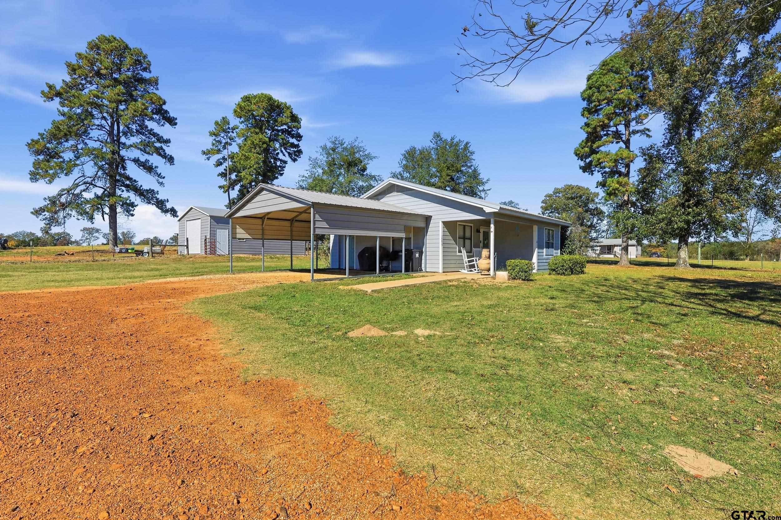 1775 County Road 1342 Pittsburg, TX 75686 - Photo 21 of 35 a front view of a house with a garden
