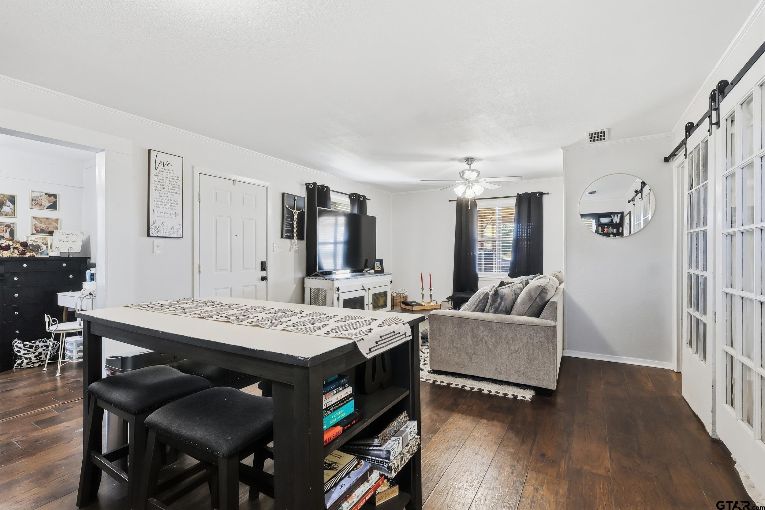 1775 County Road 1342 Pittsburg, TX 75686 - Photo 8 of 35 a view of a dining room with furniture and wooden floor