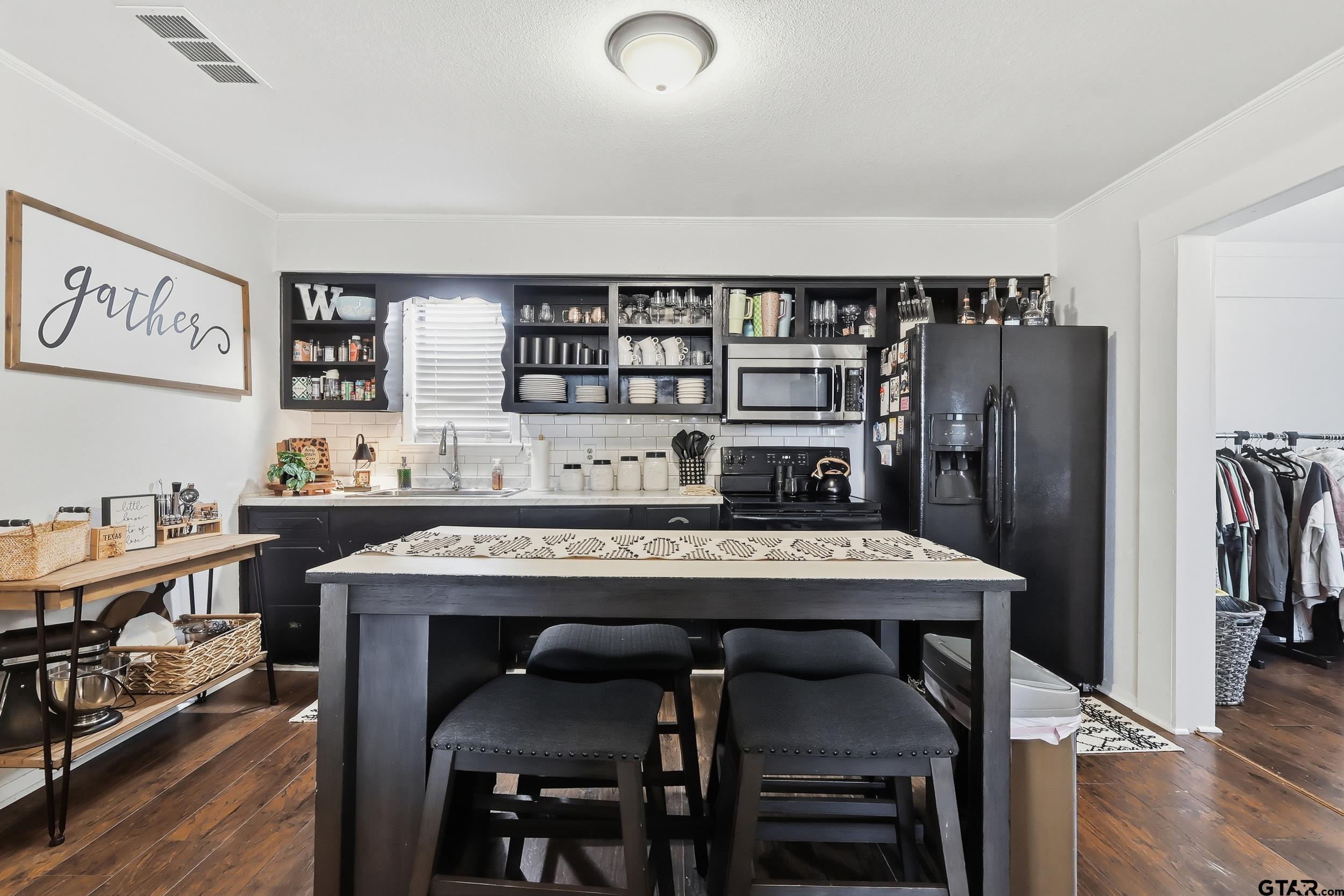 1775 County Road 1342 Pittsburg, TX 75686 - Photo 9 of 35 a view of a dining room with furniture and wooden floor