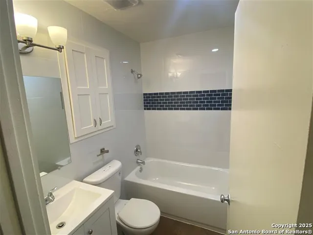 a bathroom with a toilet a sink and bathtub