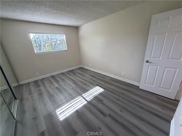 a view of an empty room and wooden floor