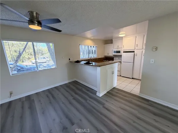 a kitchen with granite countertop a stove and a refrigerator