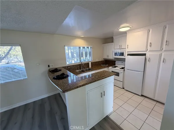 a kitchen that has a sink and a stove top oven