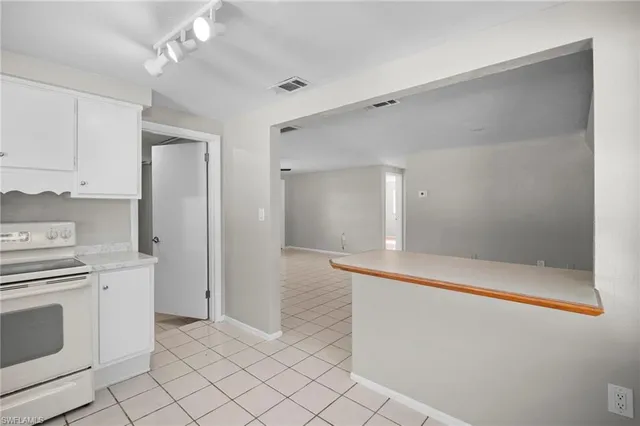 a view of a kitchen with white cabinets
