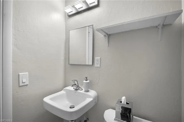 a bathroom with a sink mirror and vanity