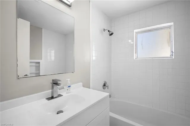 a bathroom with a sink a vanity and a mirror