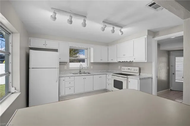 a kitchen with a refrigerator stove and sink