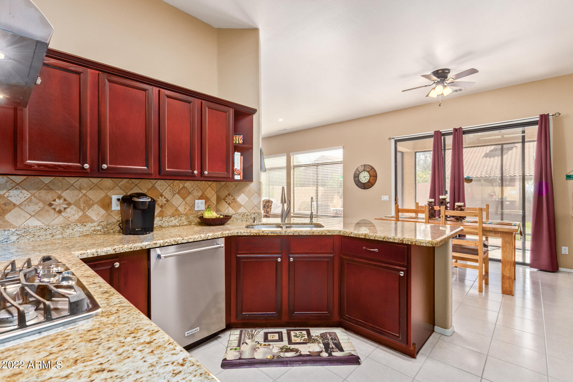 4515 East Jaeger Road Phoenix, AZ 85050 - Photo 13 of 27 a kitchen with a sink and wooden cabinets